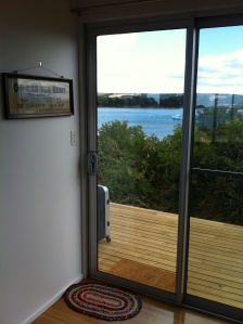 Throught the new sliding door on the western side, across the deck to the lagoon beyond